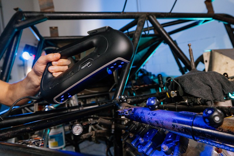 An EP9 Autosport technician using a Creaform HandySCAN 3D|PRO Series to capture the geometry of the race car’s engine head.